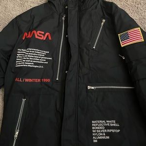 Black NASA puffer jacket with hoodie. Fits both men and women